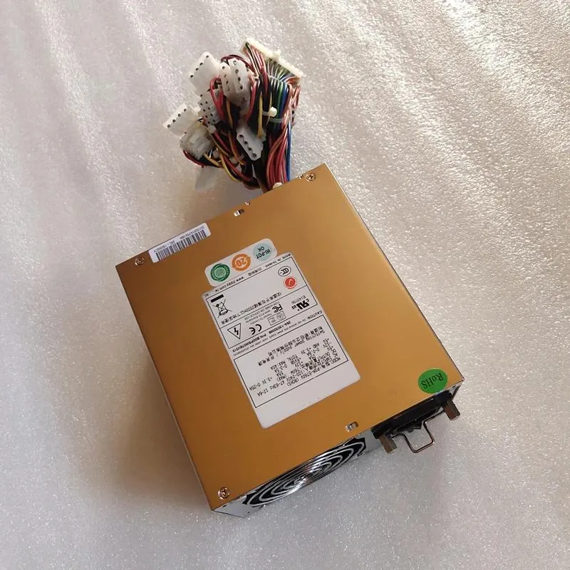 Rectangular silver ATX power supply unit with fan grille and cable bundle