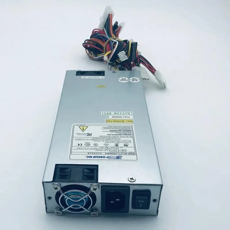 Compact silver ATX power supply unit with rear fan grille and cable bundle