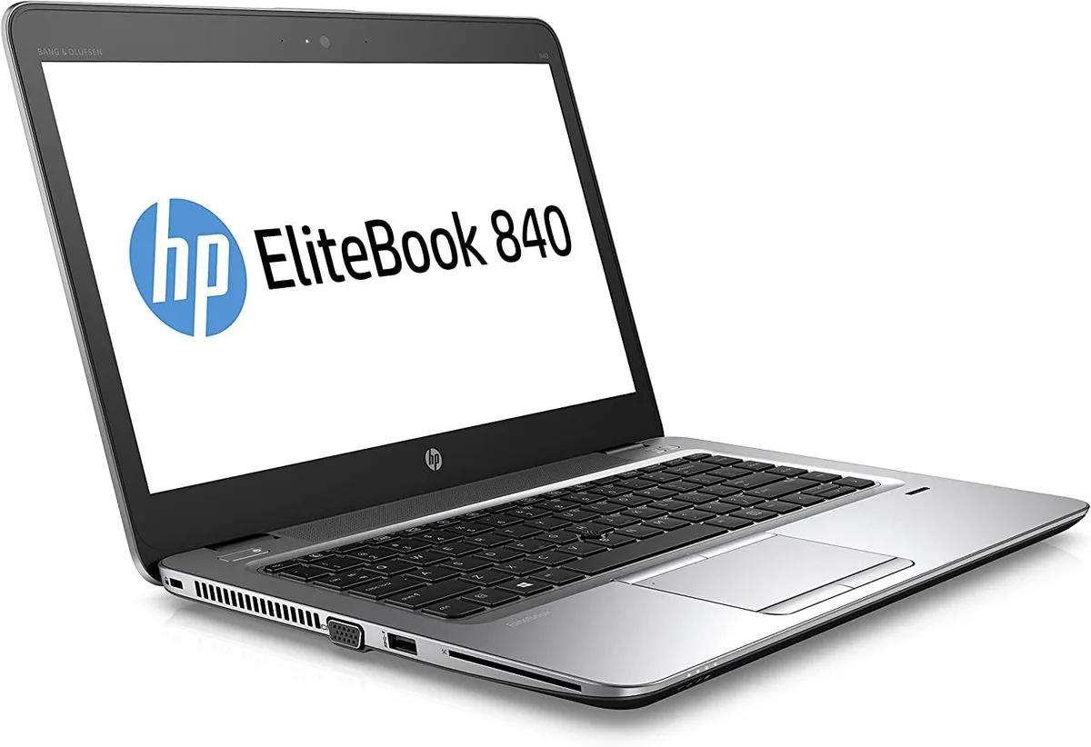 Silver 14-inch business laptop with visible wear marks on the lid and corners