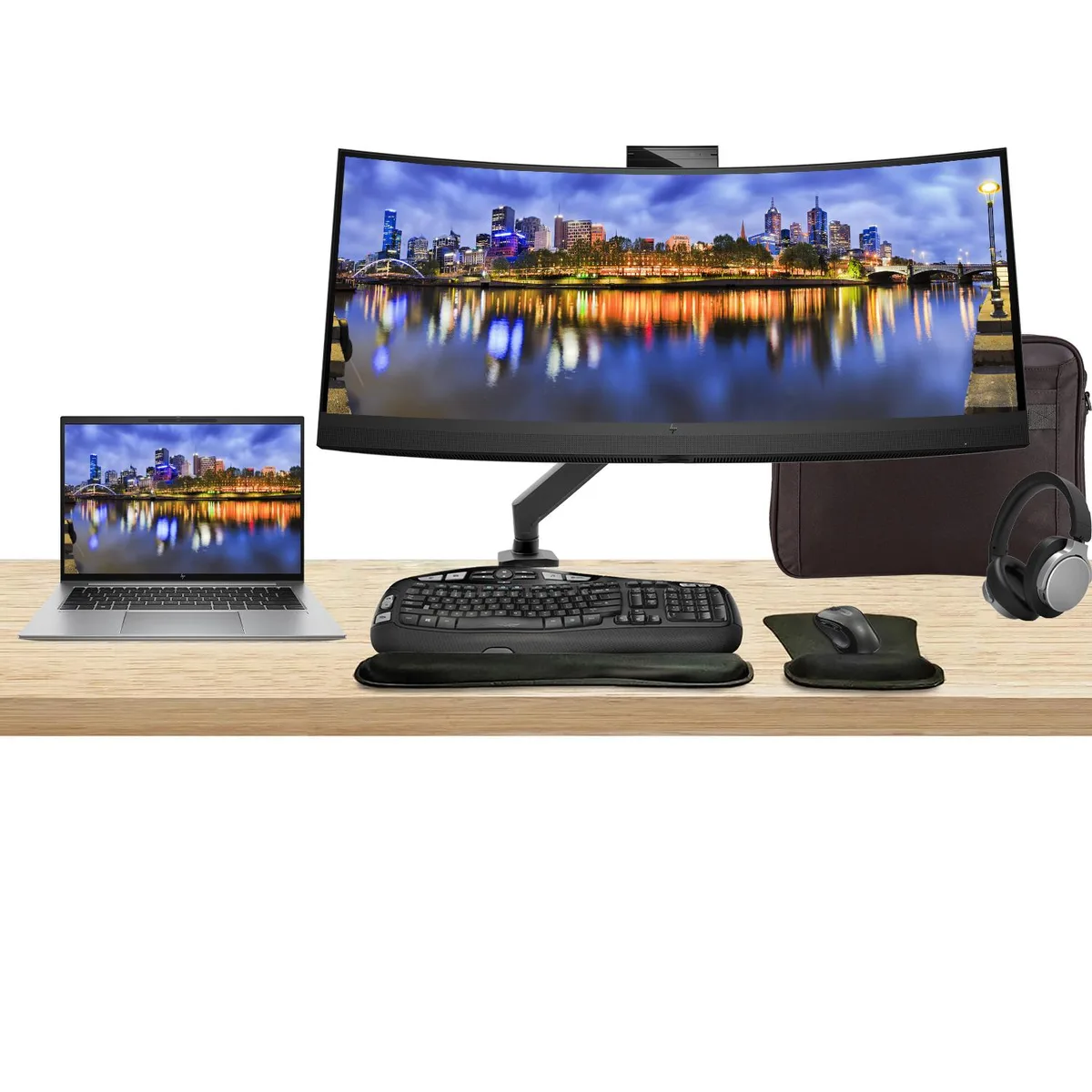 Silver 14 inch touchscreen laptop beside 34 inch curved monitor with webcam, plus keyboard, mouse, headphones and briefcase