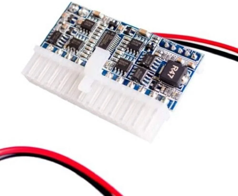 Small green circuit board with 24-pin ATX connector and soldered components