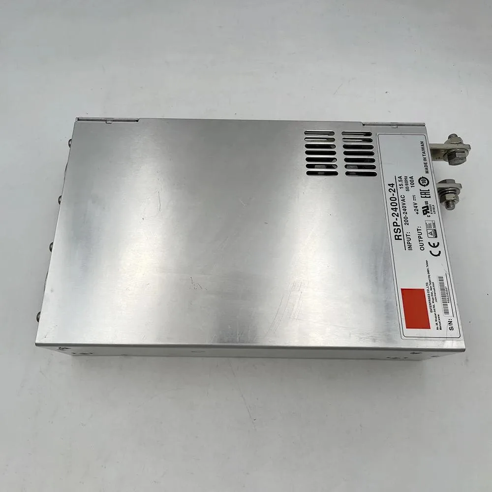 Rectangular metal power supply unit with ventilation slots and terminal connections