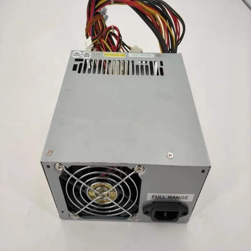 Rectangular metal ATX power supply unit with ventilation grille and cooling fan