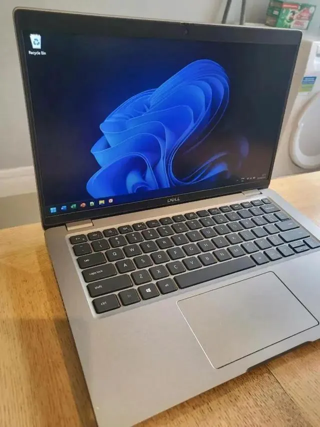Silver 14 inch Dell Latitude 5421 laptop closed on a plain background
