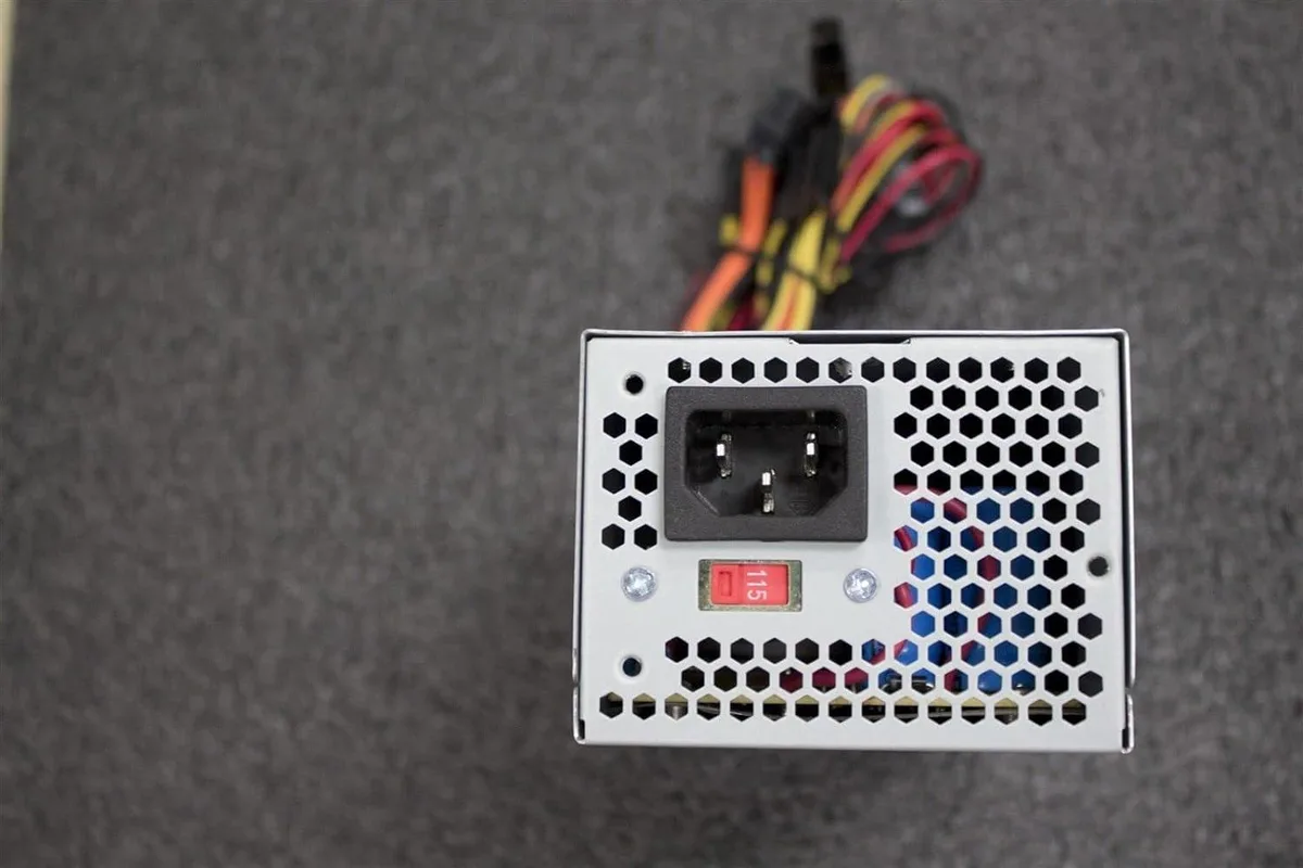 Compact TFX power supply unit with 80mm cooling fan and multiple cable connectors