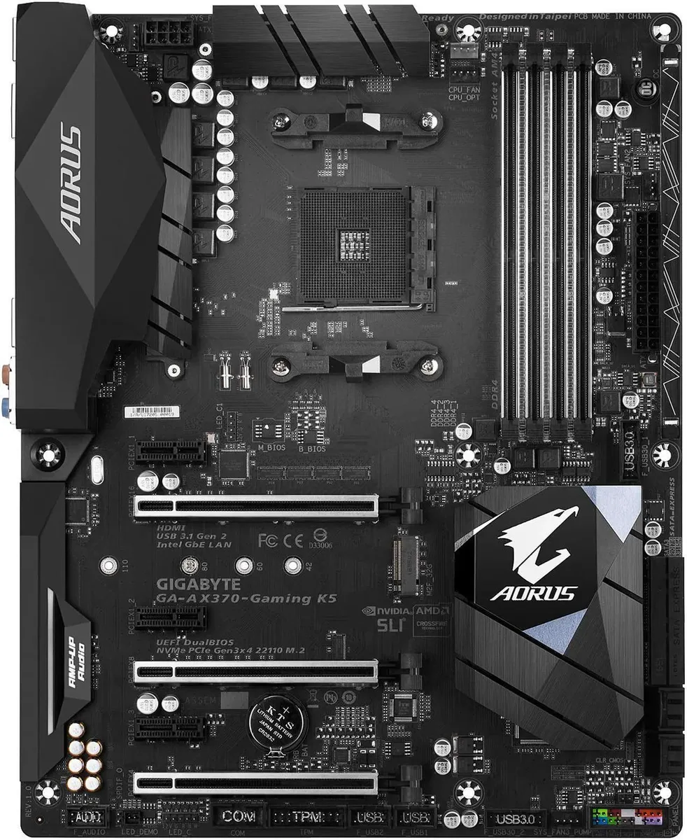 ATX motherboard in black with silver heatsinks and multiple expansion slots
