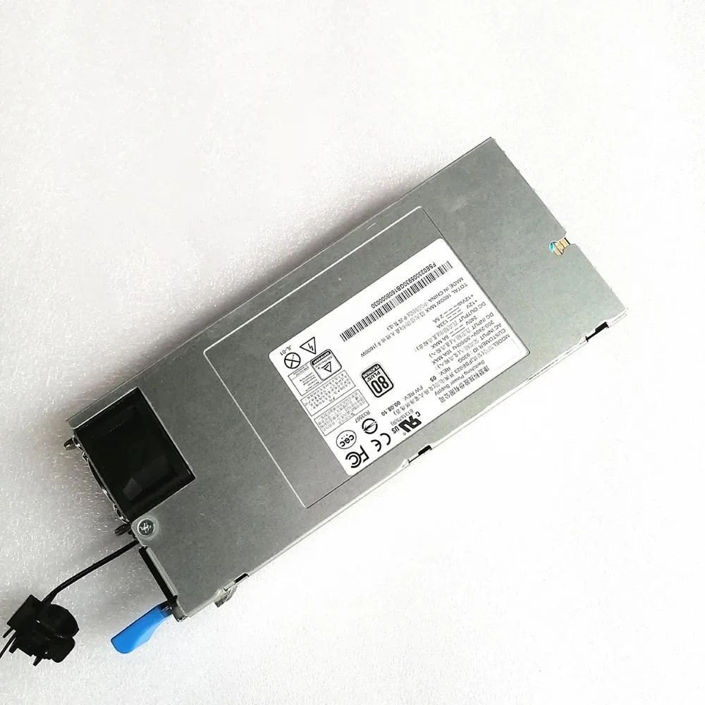 Rectangular metal ATX power supply unit with fan grille and cable bundle
