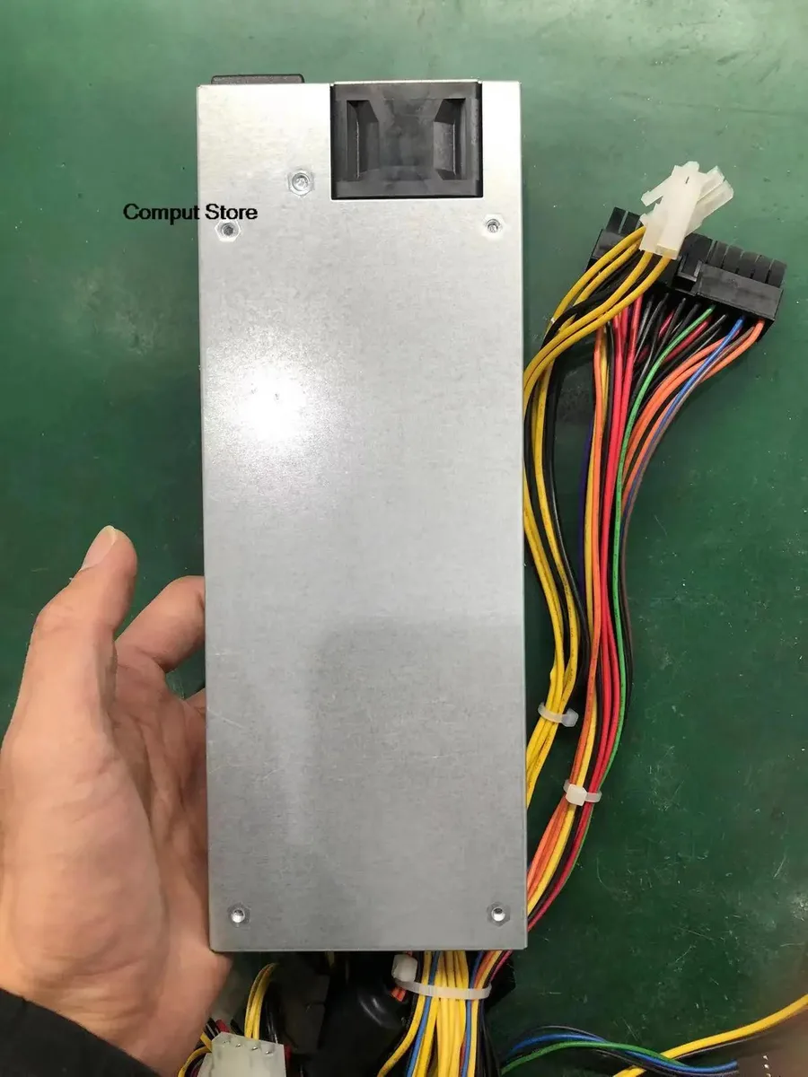 Rectangular metal ATX power supply unit with ventilation grille and power connectors