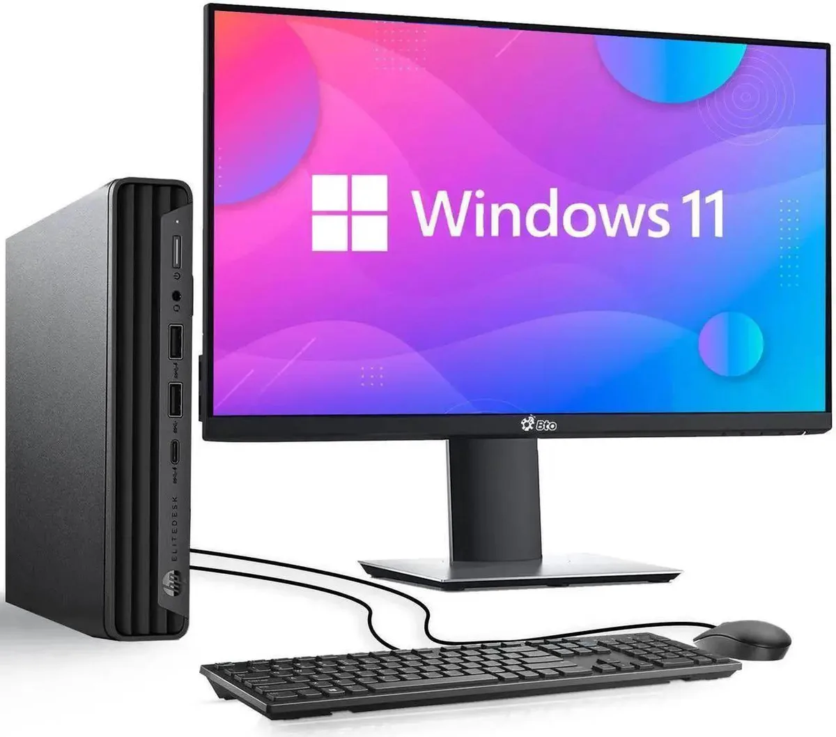 Tiny black desktop unit beside 22-inch monitor with wired keyboard and mouse