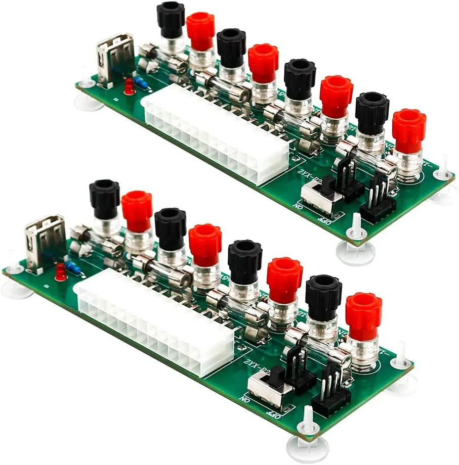 Two green ATX breakout boards with 24-pin connectors USB ports binding posts and fuses