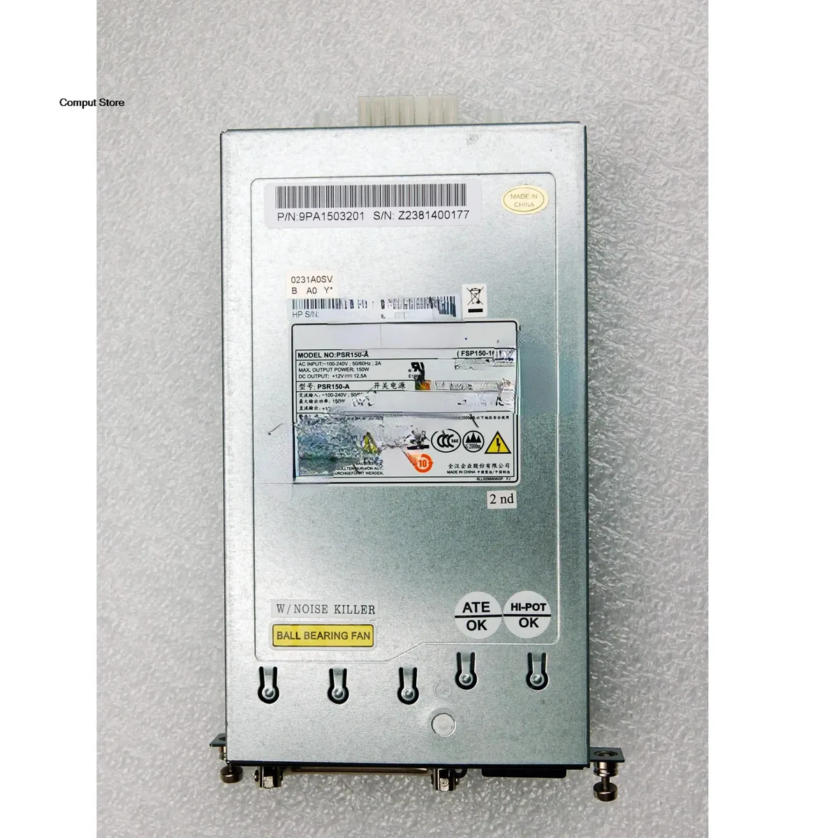 Compact silver ATX power supply unit with ventilation grille and power socket visible