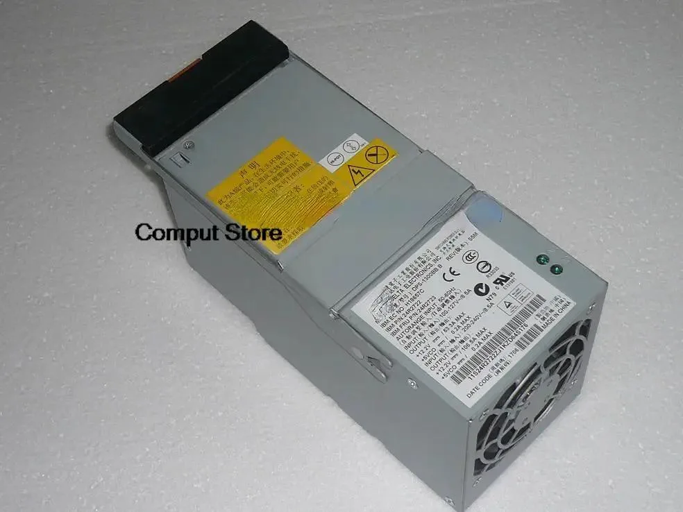 Rectangular silver ATX power supply unit with ventilation grille and label showing model numbers