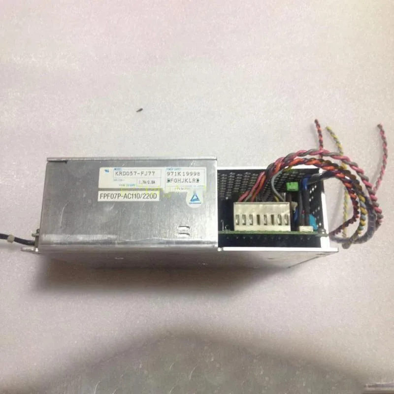 Silver rectangular ATX power supply unit with fan grille and AC input label
