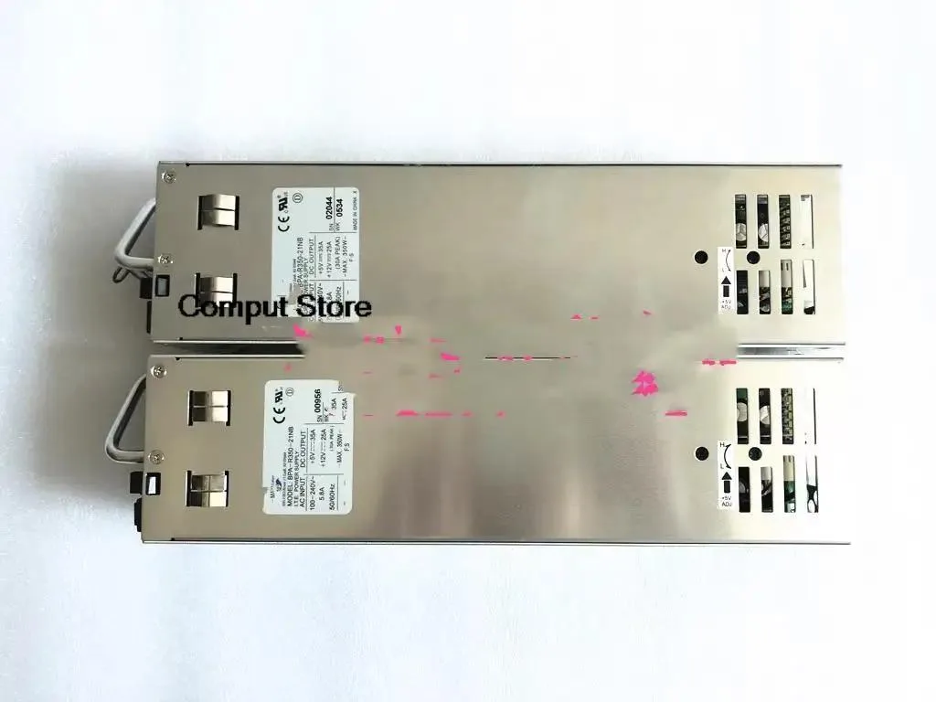 Silver metal ATX power supply unit, rectangular box with ventilation grille and cable bundle