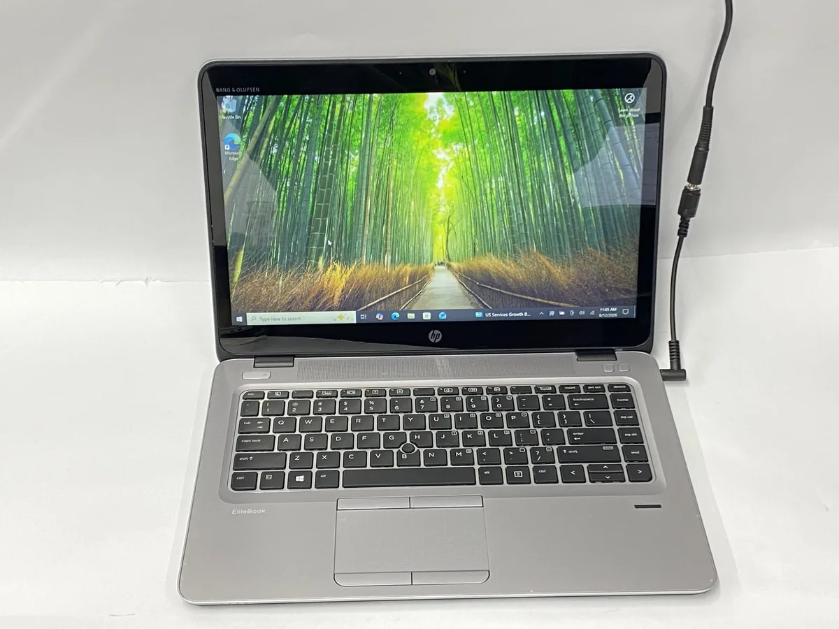 Silver 14 inch HP 840 G4 laptop with touchscreen display, visible scratches and scuffs on lid