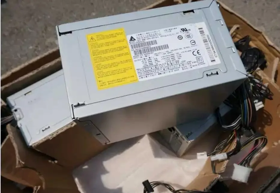Rectangular metal ATX power supply unit, matte finish, cooling fan visible
