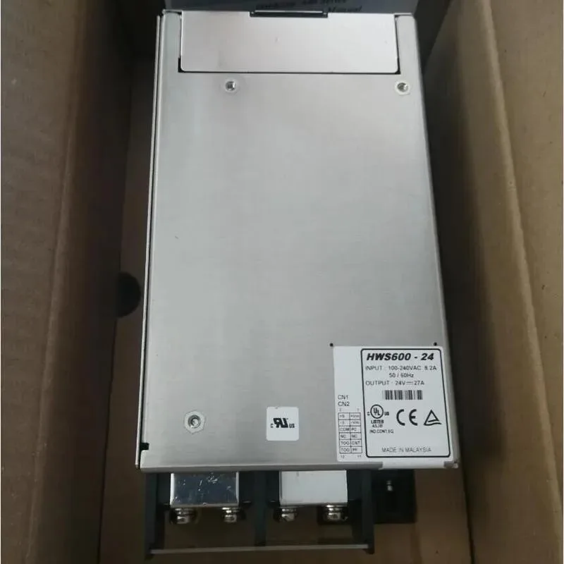 Rectangular metal power supply unit with ventilation slots and terminal connectors