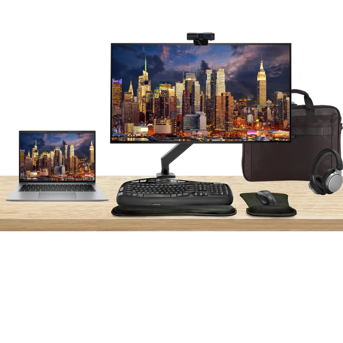 Silver 14 inch touchscreen laptop beside 32 inch 4K monitor with wireless keyboard, mouse, webcam, headphones and briefcase