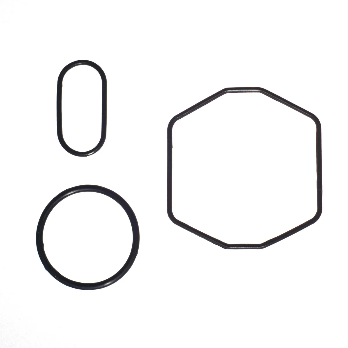 Three black rubber O-rings on a light surface