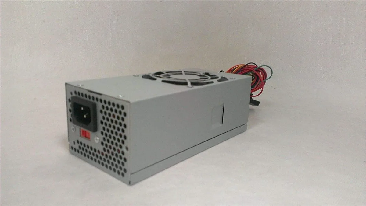 Compact silver TFX power supply unit with 80mm fan grille and cable bundle