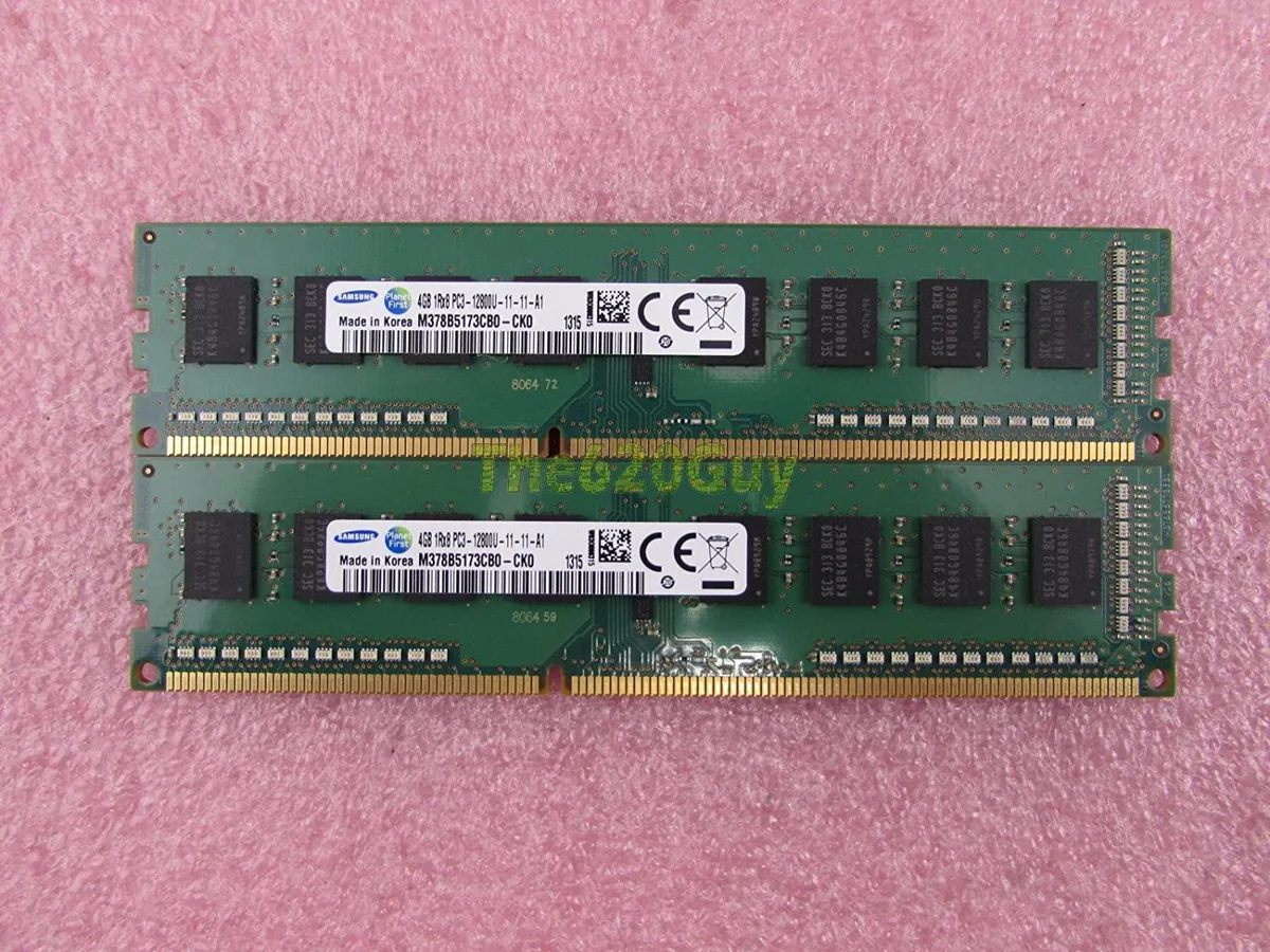 Two green circuit boards with black memory chips and gold edge connectors