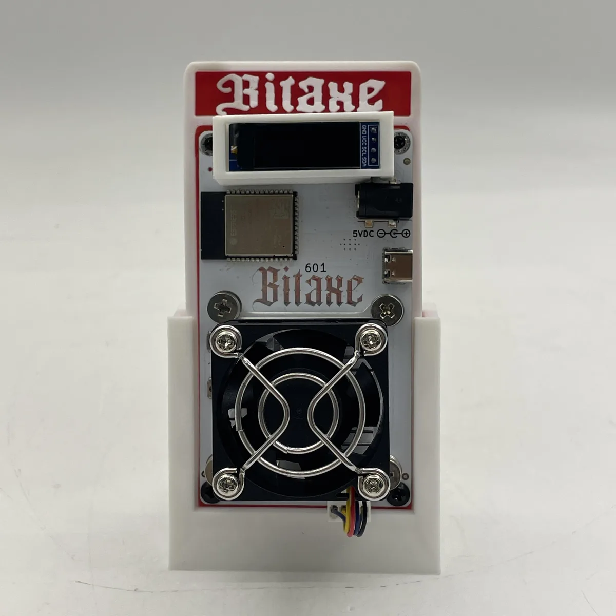 Compact Bitaxe Gamma 601 solo miner in black enclosure with US power supply included