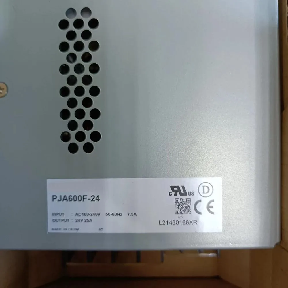 Rectangular metal power supply unit with ventilation slots and terminal connections