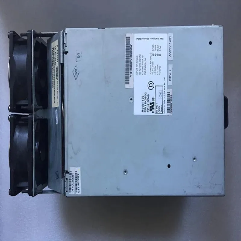 Rectangular silver ATX power supply unit with ventilation grille and label stickers