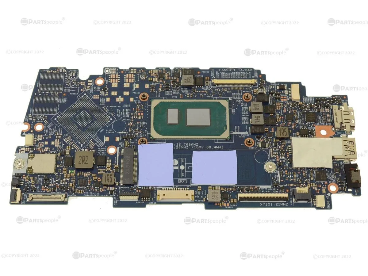 Green laptop motherboard with soldered CPU and RAM, silver heatsink visible