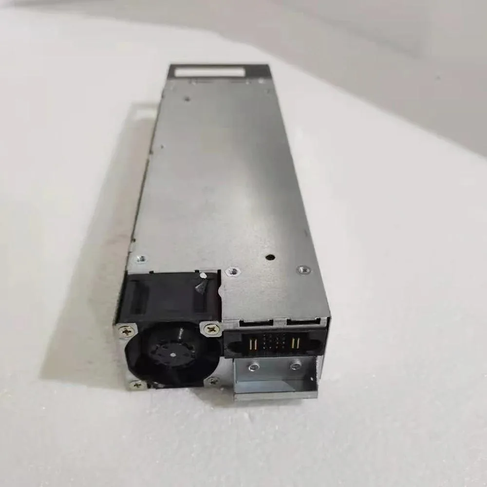 Rectangular metal power supply unit with ventilation slots and connector panel
