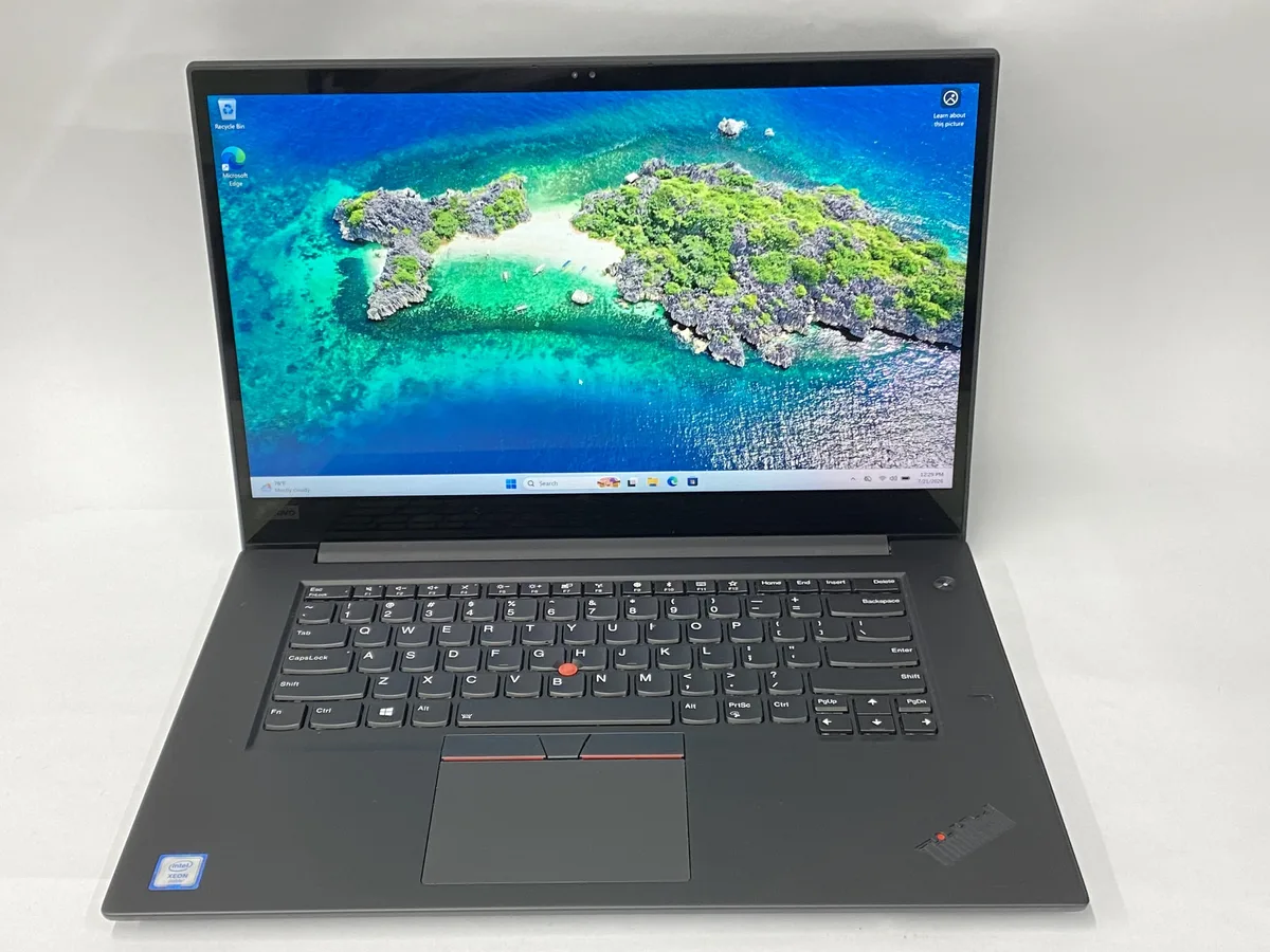 Black ThinkPad P1 laptop open showing 15.6 inch touchscreen display