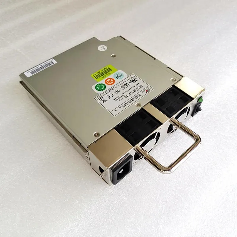 Rectangular silver ATX power supply unit with fan grille and side label