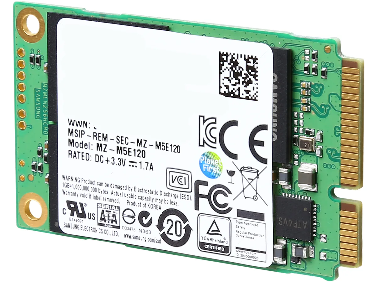 Small rectangular green circuit board with gold edge connector and black chips