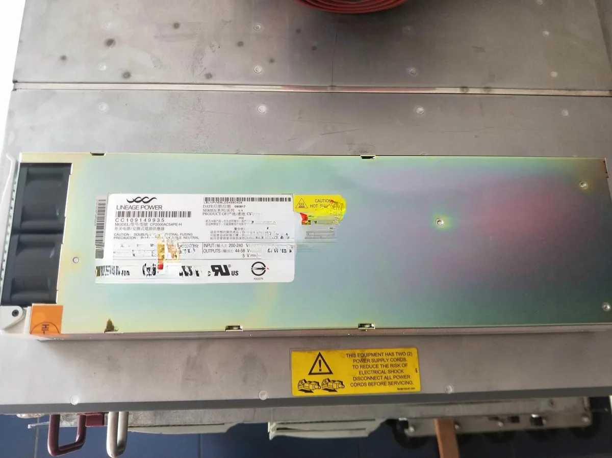 Rectangular silver power supply module with ventilation slots