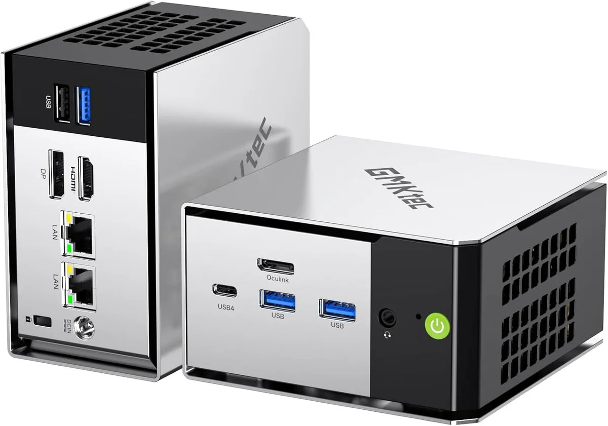 Compact silver-and-black mini PC with rounded edges
