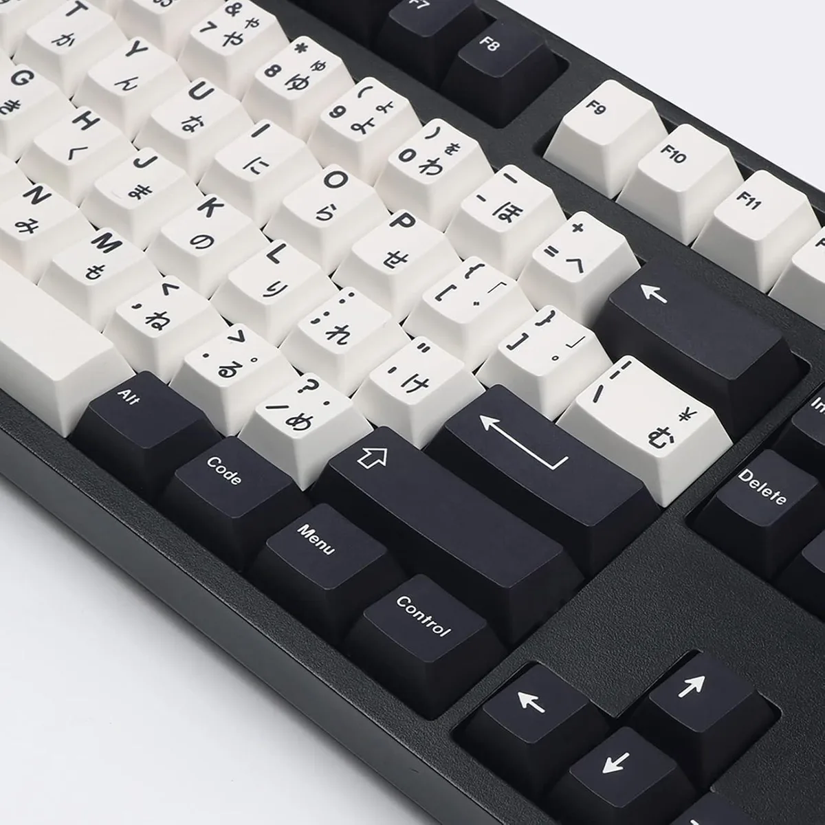 Black and white PBT keycaps in Cherry profile, 133 keys laid out on a flat surface