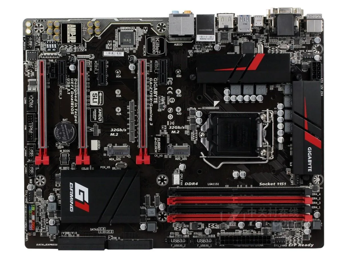 Rectangular ATX motherboard, black PCB with silver and orange accents, CPU socket and four memory slots visible
