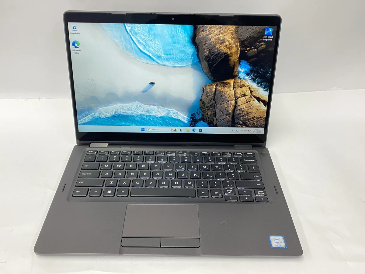 Silver Dell Latitude 5300 2-in-1 laptop with 13 inch touchscreen display, visible scratches on lid and base