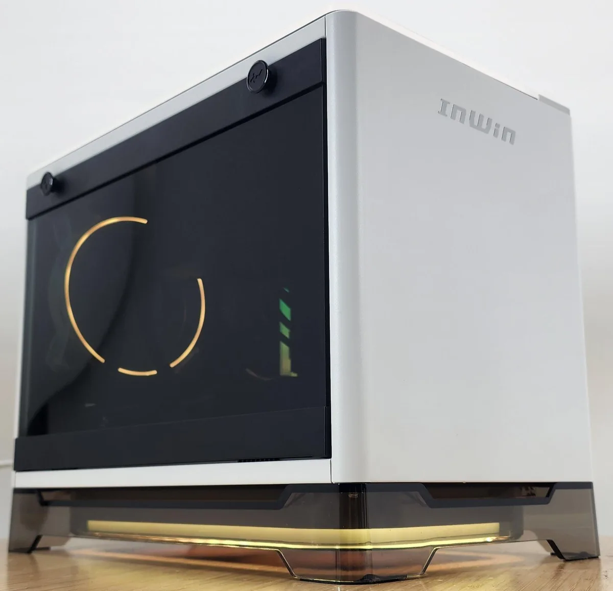 White compact gaming tower with glass side panel and RGB lighting inside