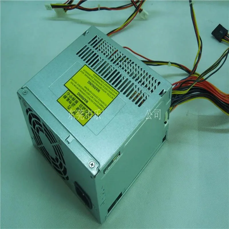 Rectangular metal ATX power supply unit, matte grey finish, rear fan grille and power socket visible