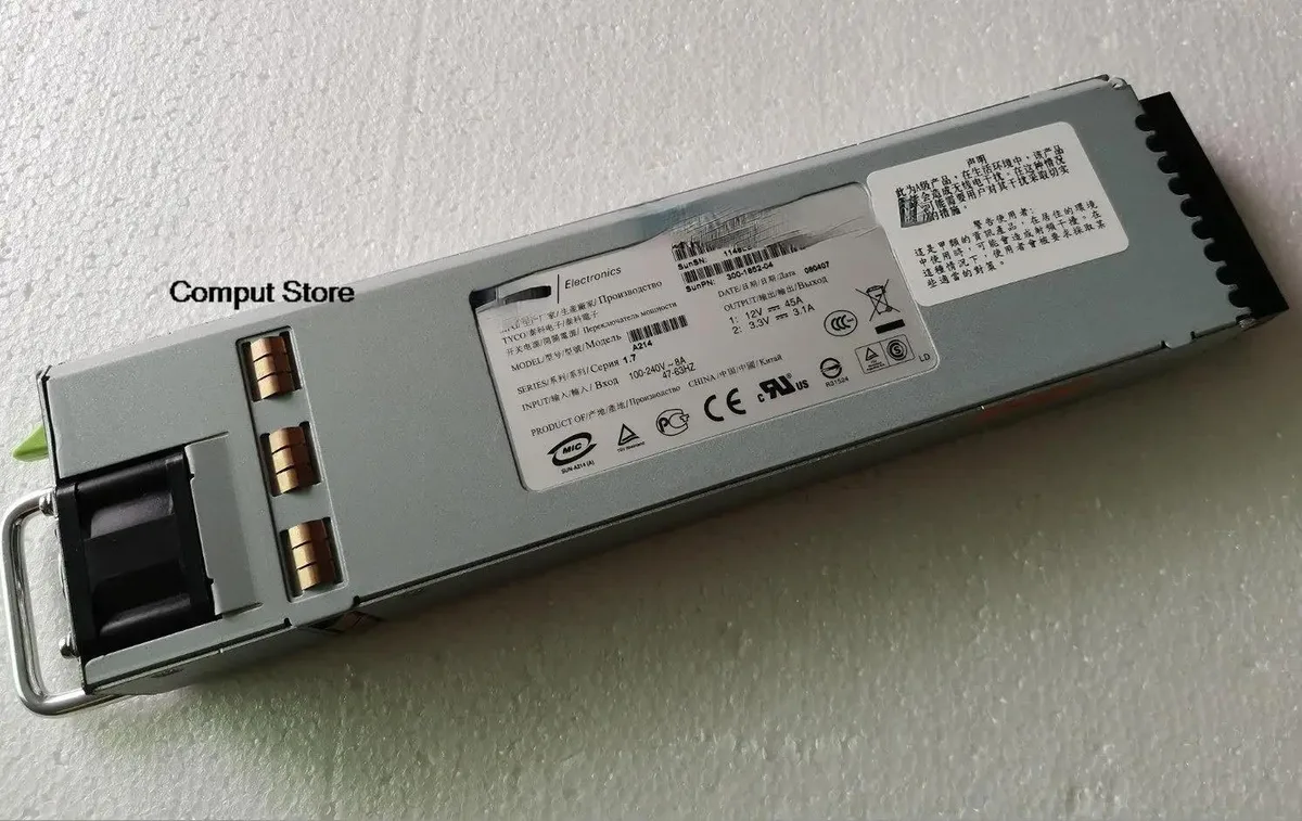 Rectangular silver metal ATX power supply unit with ventilation grille and label showing Tyco A214