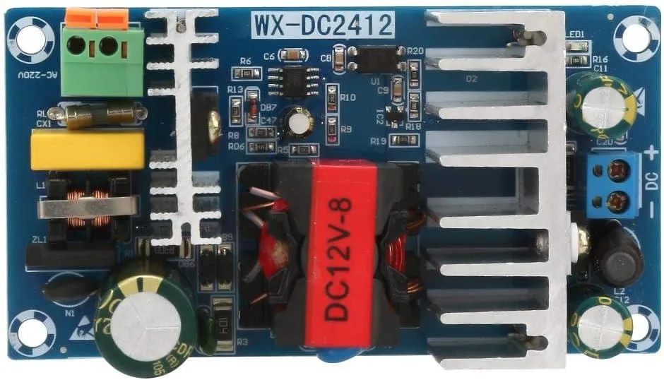 Green rectangular circuit board with components, mounting holes, and screw terminals