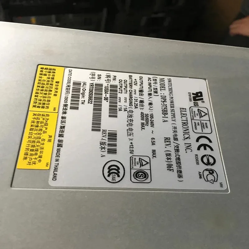 Rectangular silver ATX power supply unit with fan grille and power socket