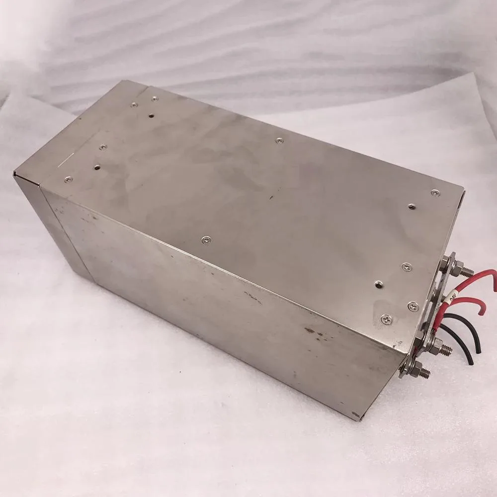 Rectangular metal power supply unit with ventilation grille and label showing 24V 37.6A 1000W
