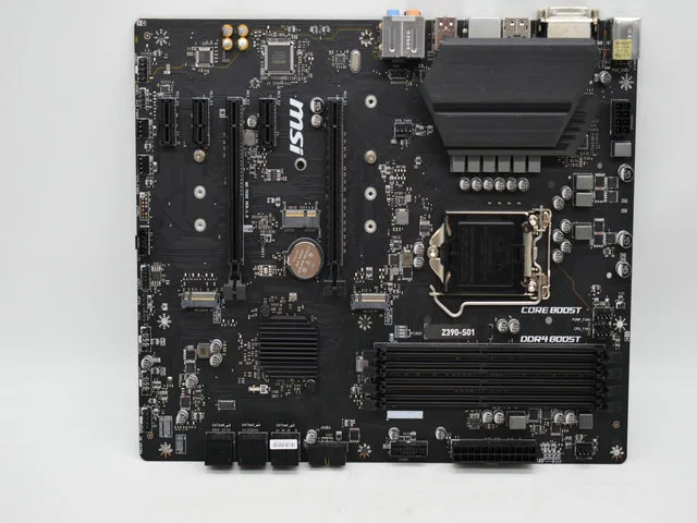 Green ATX motherboard with black slots, silver heatsinks and rear I/O shield