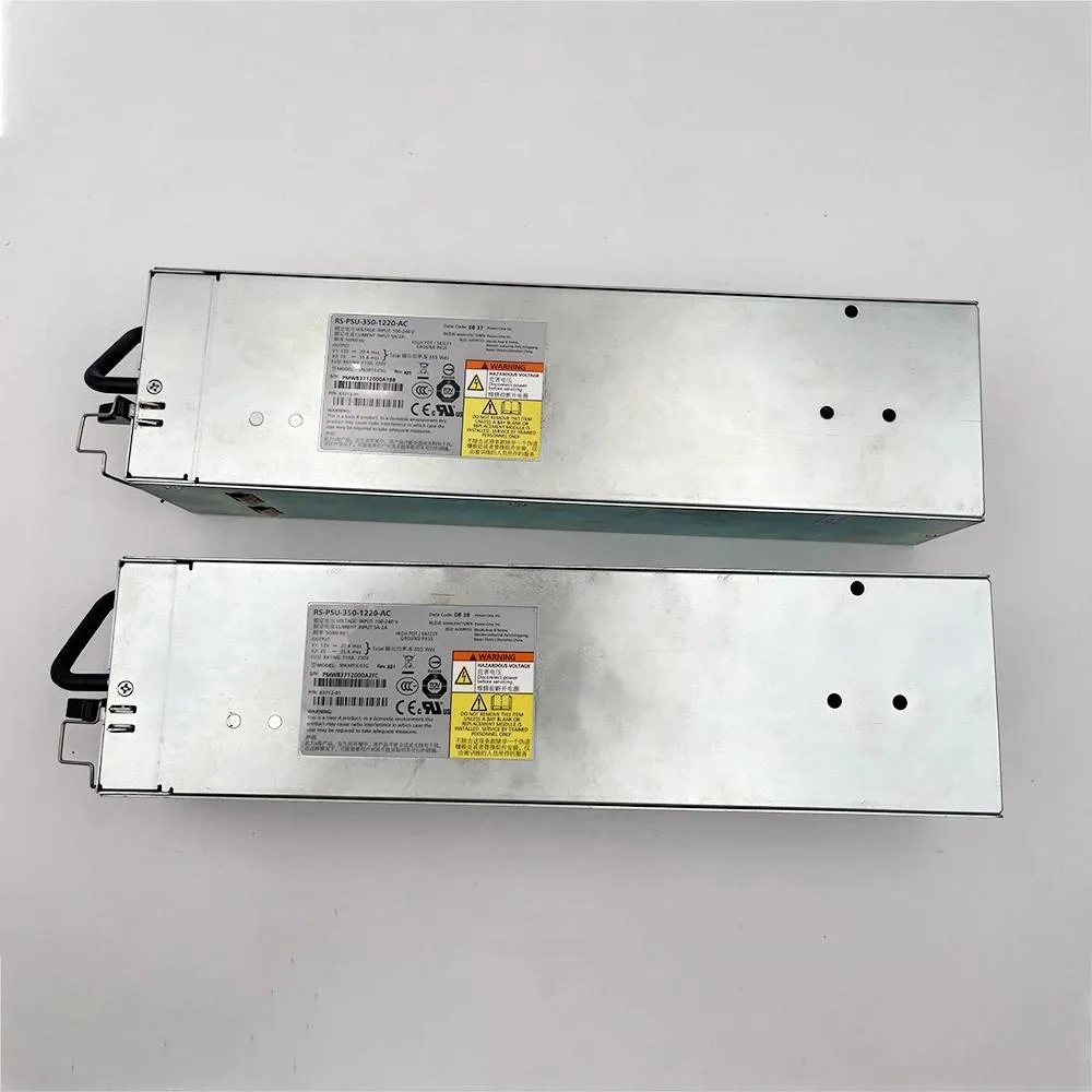 Rectangular silver metal power supply unit with ventilation grille and rear connector panel