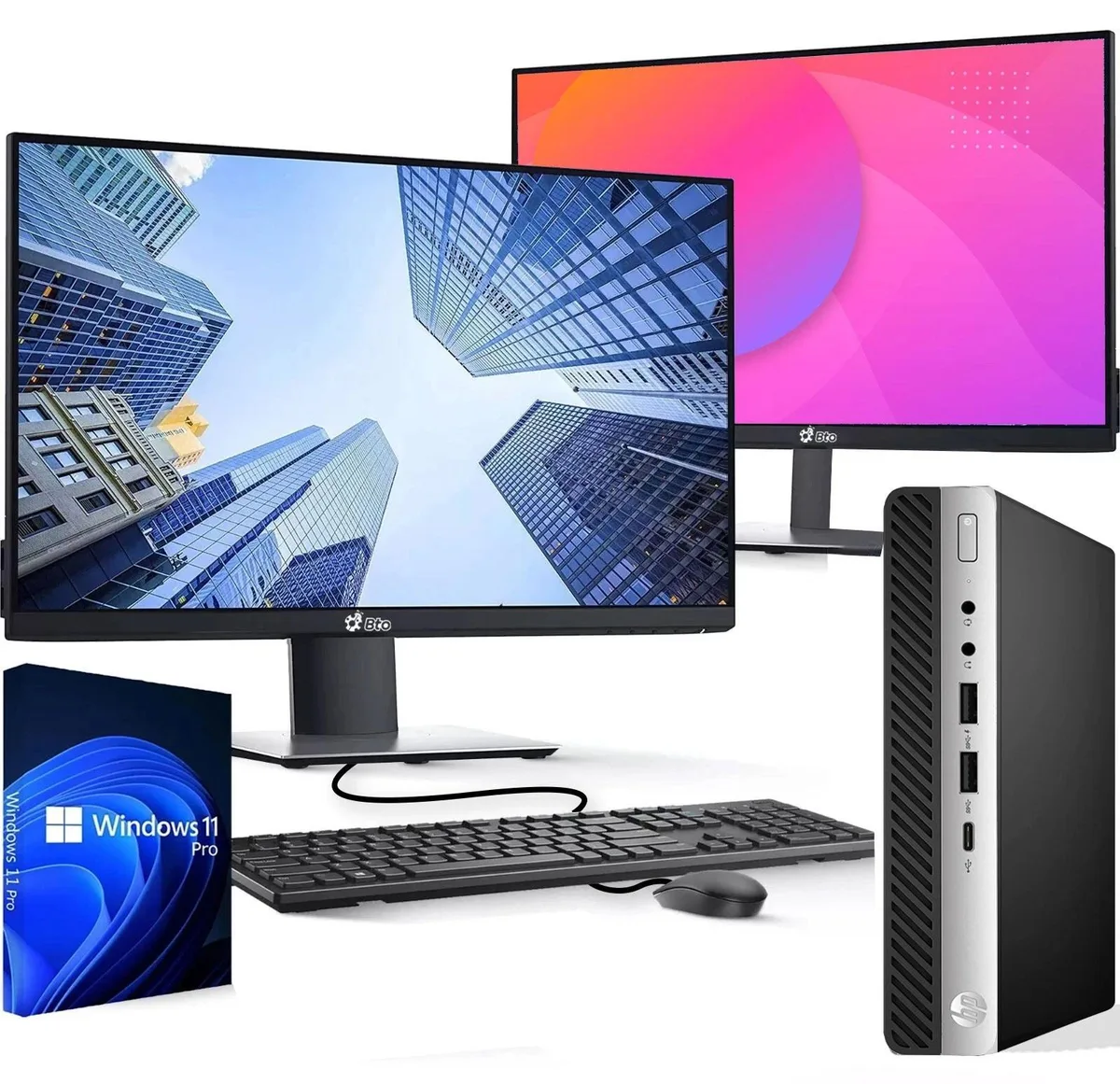 Tiny black desktop tower beside two 24-inch monitors with keyboard and mouse