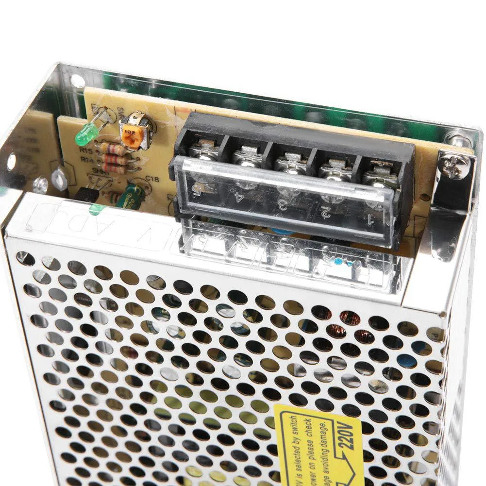 Rectangular silver metal power supply unit with terminal blocks and voltage selector switch