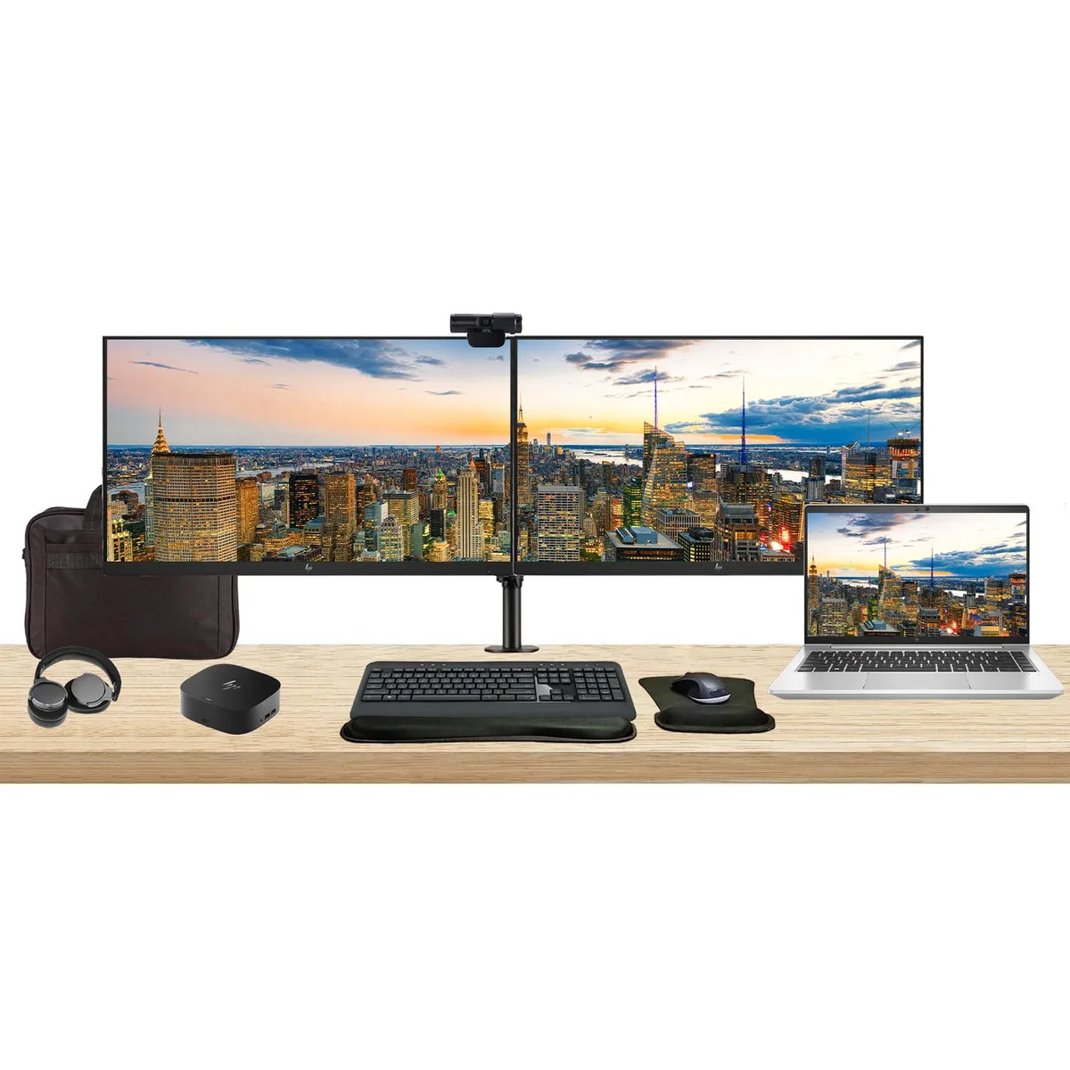 Silver 14 inch laptop on dual monitor stand with two 27 inch screens, dock, keyboard, mouse, webcam, headphones and briefcase