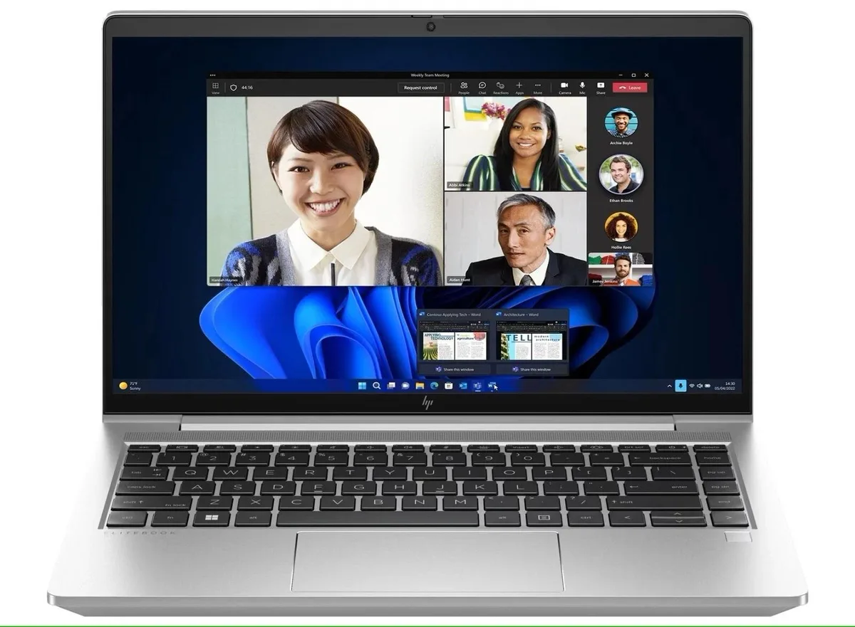 Silver 14 inch laptop with visible scratches and shiny keyboard areas